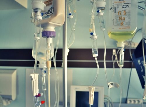 Vertical shot of a medical facility with IV drips and monitors, capturing a clinical healthcare environment.
